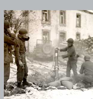 Soldiers of a chemical battalion attached to the 35th Infantry Division fire a 4.2 inch mortar in Belgian town near Bastogne.